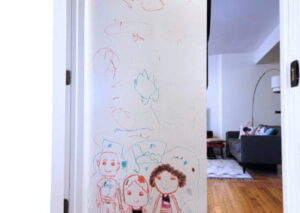 Fresh installed whiteboard wall submittled with white board paint review from Laura Cole with dry erases drawings from her 4-year-old daughter.