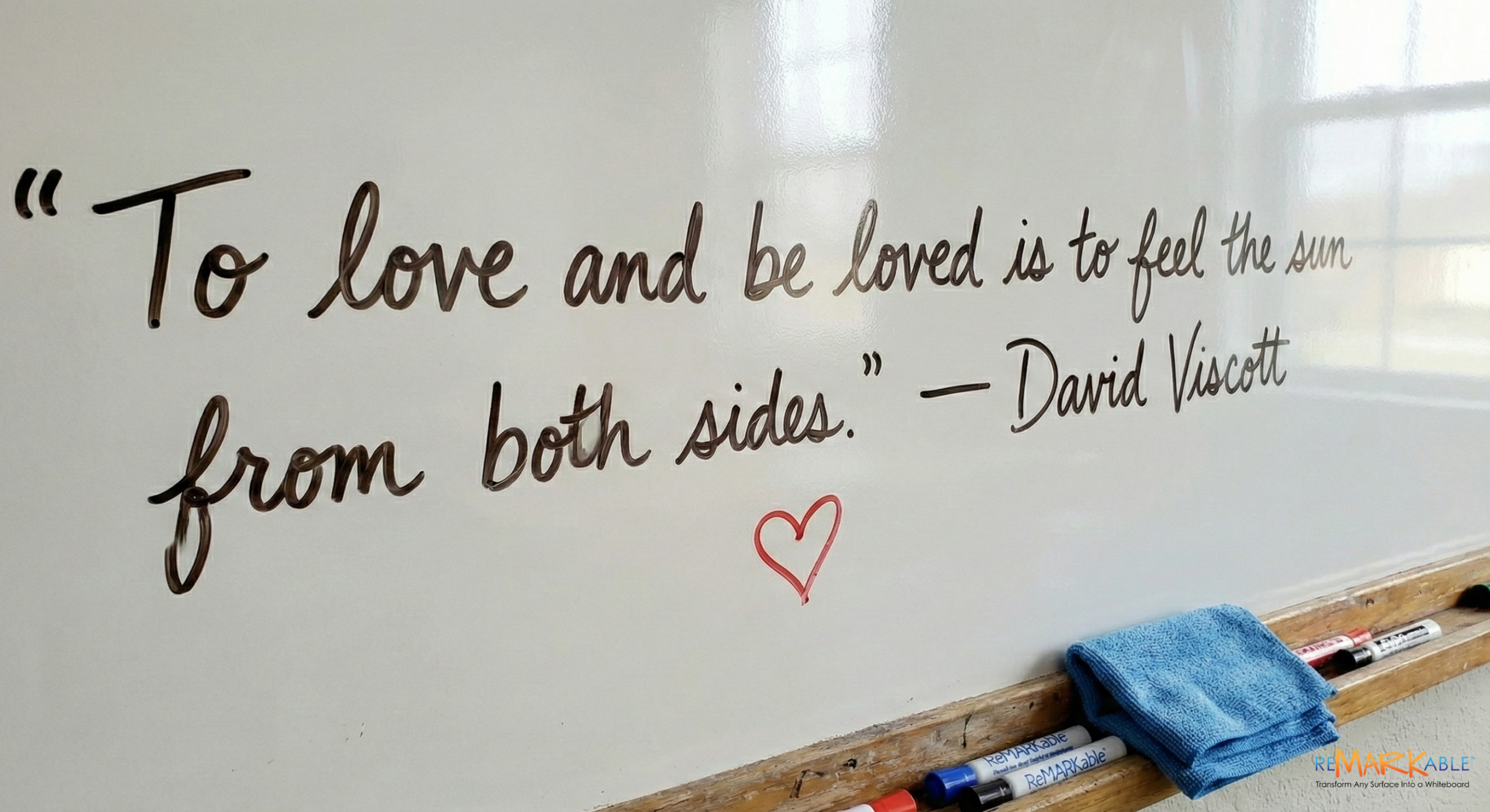 Inspirational love quotes on a whiteboard wall for February